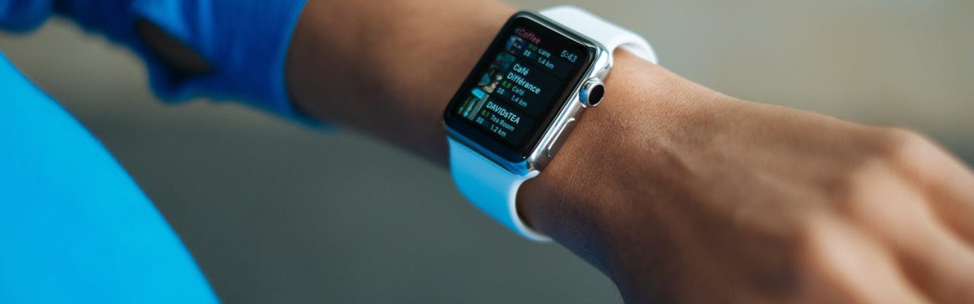 Focus on a smartwatch worn on an adult's wrist, showcasing its digital display.